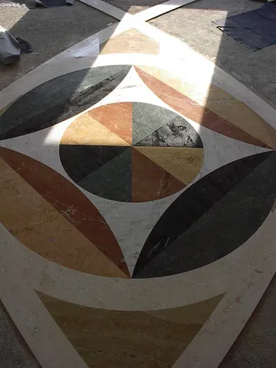 Pavimento in marmo con intarsio geometrico a motivi circolari